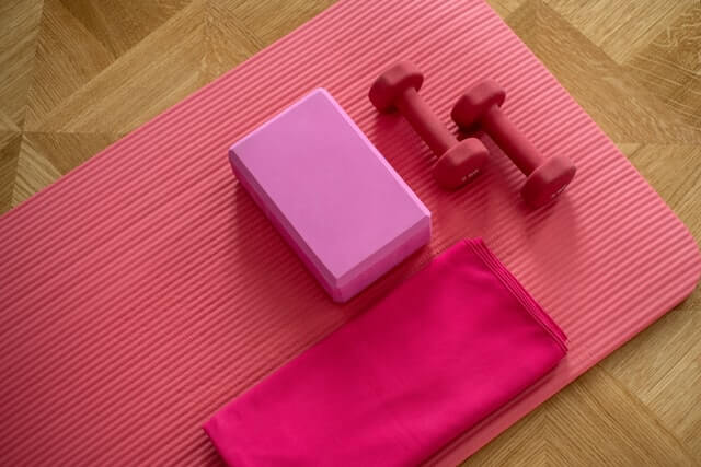 Easy Guide to Exercise at Home in the Lockdown pink exercise mat with weights Photo by Elena Kloppenburg on Unsplash
