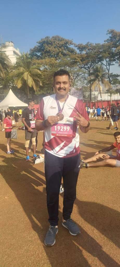  marathons Man Showing Wining medal
